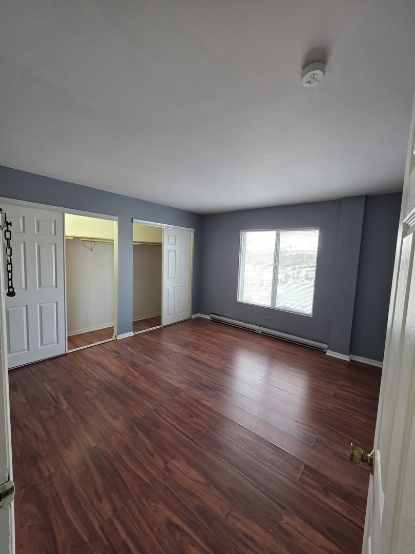 336 Lathrop Avenue, Unit 502 Forest Park, IL 60130 - Photo 20 of 38 an empty room with wooden floor and windows