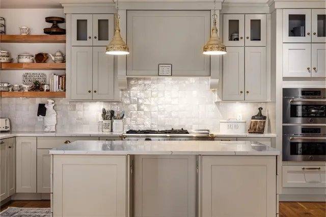 a kitchen with stainless steel appliances granite countertop a sink and cabinets