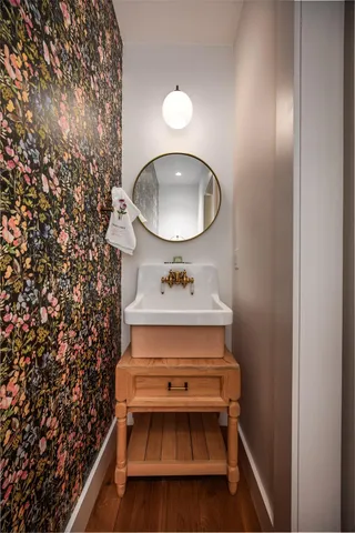 a bathroom with a sink toilet and mirror