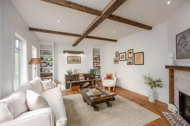 a living room with furniture gym equipment and a fireplace