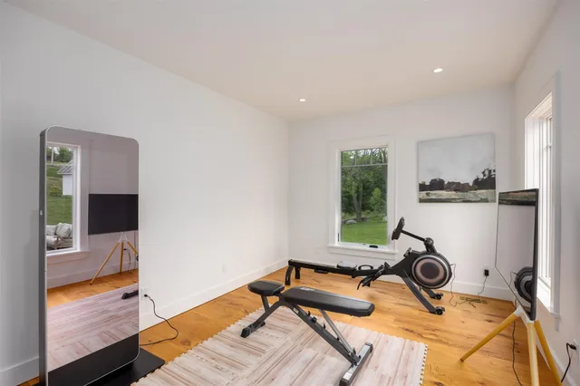 a room with gym equipment and view of living room