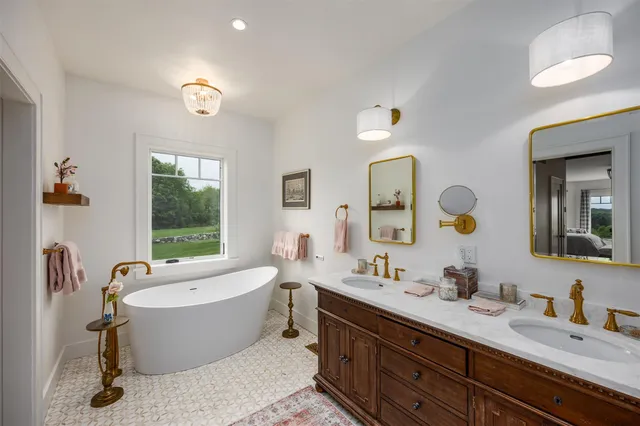 a bathroom with a large tub and sink