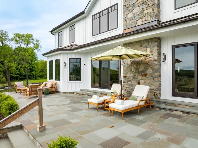 a view of a patio with couple of couch and chairs