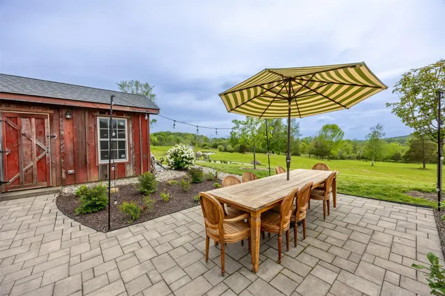 a view of a patio with a table and chairs