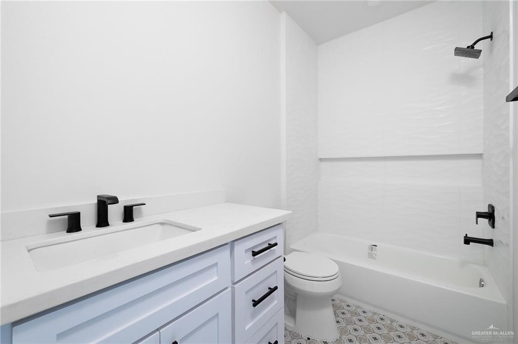 2015 Cassandra Street Mission, TX 78572 - Photo 12 of 15 a bathroom with a sink a toilet and bathtub