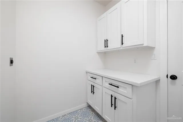 a kitchen with white cabinets and white appliances