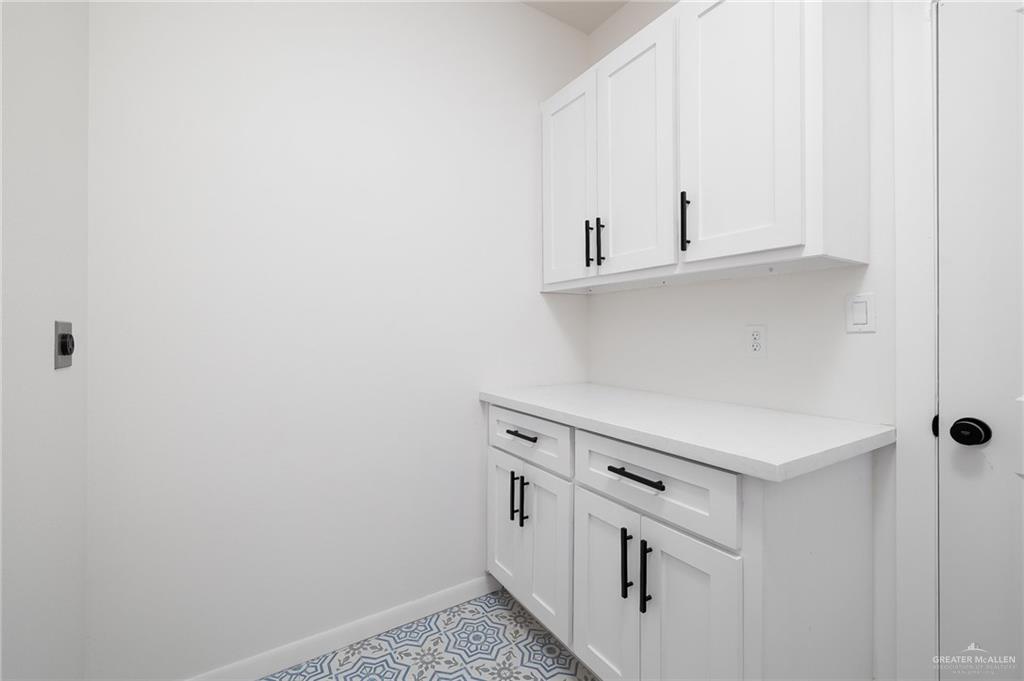 2015 Cassandra Street Mission, TX 78572 - Photo 14 of 15 a kitchen with white cabinets and white appliances