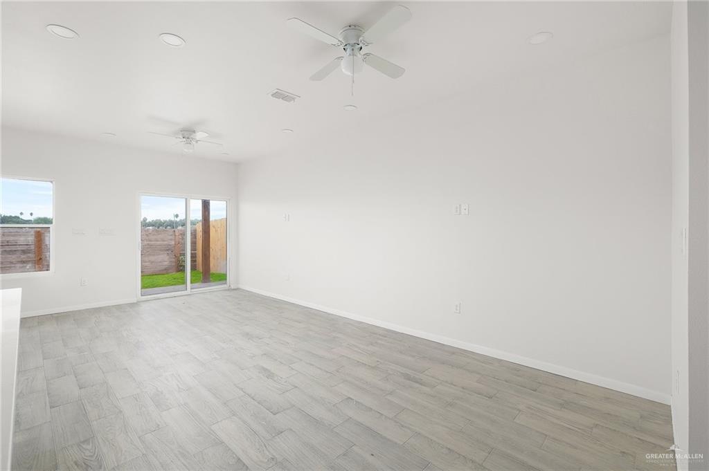 2015 Cassandra Street Mission, TX 78572 - Photo 2 of 15 an empty room with wooden floor and windows