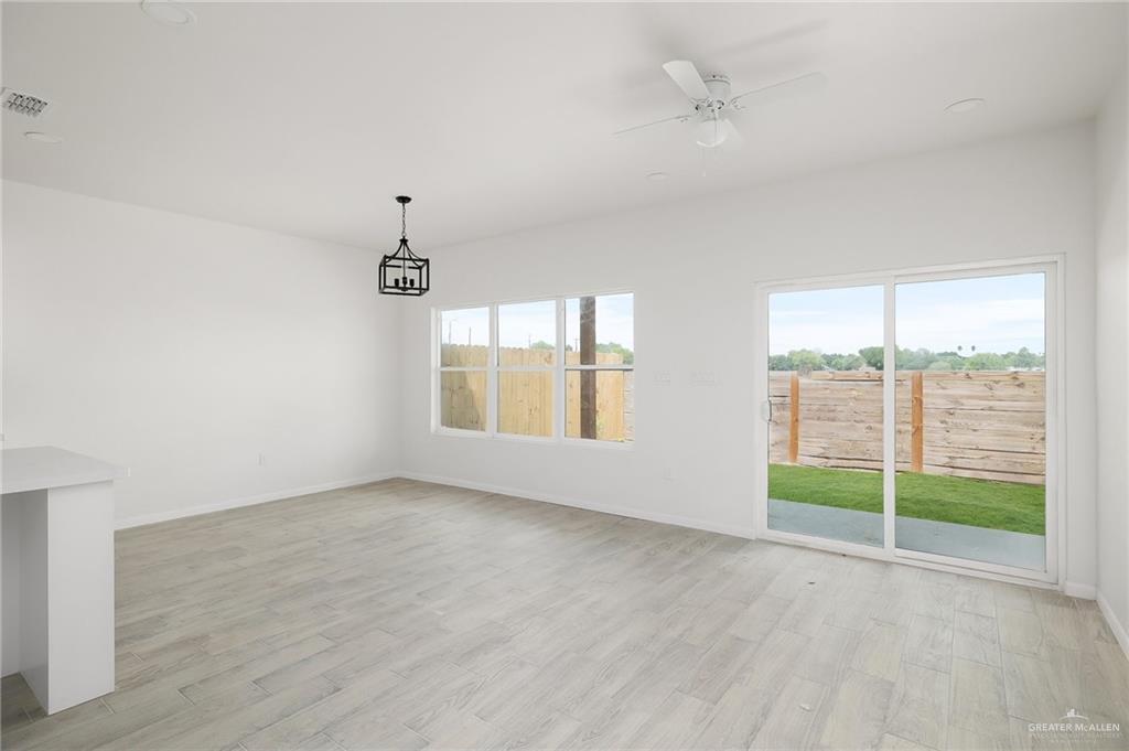 2015 Cassandra Street Mission, TX 78572 - Photo 3 of 15 wooden floor in an empty room with a window