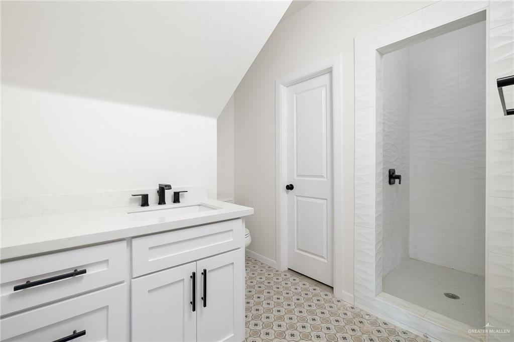 2015 Cassandra Street Mission, TX 78572 - Photo 8 of 15 a bathroom with a sink a toilet and shower