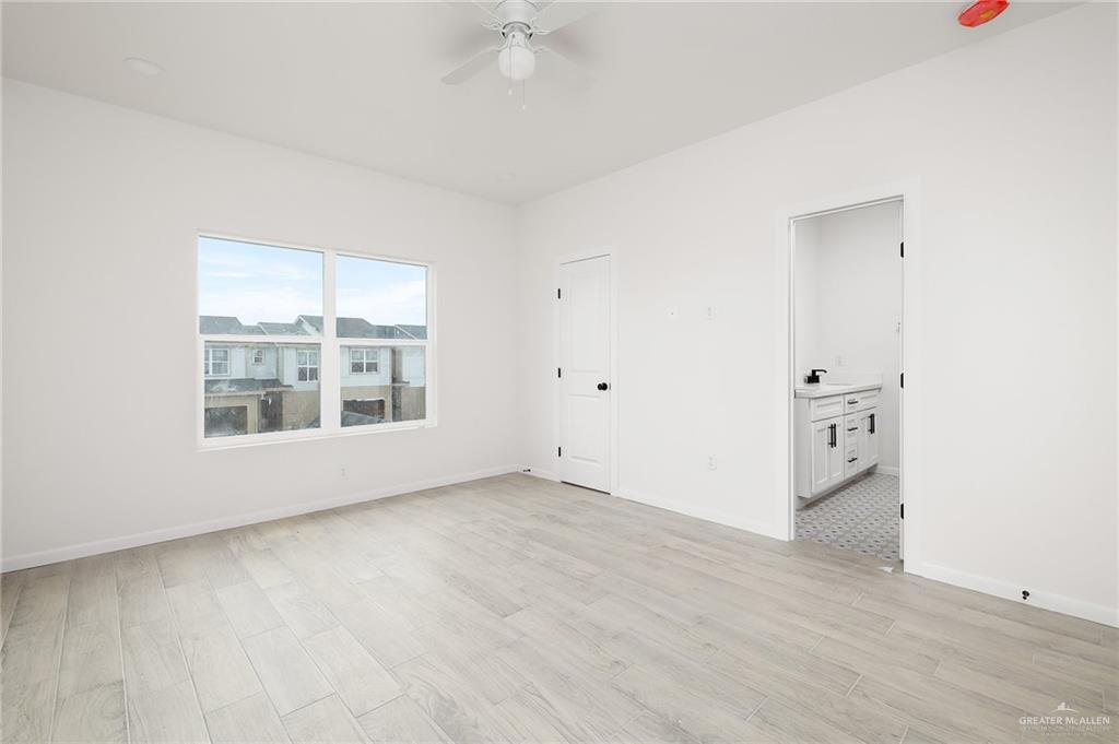 2015 Cassandra Street Mission, TX 78572 - Photo 9 of 15 an empty room with wooden floor and windows