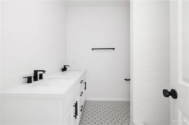 a bathroom with a sink and mirror