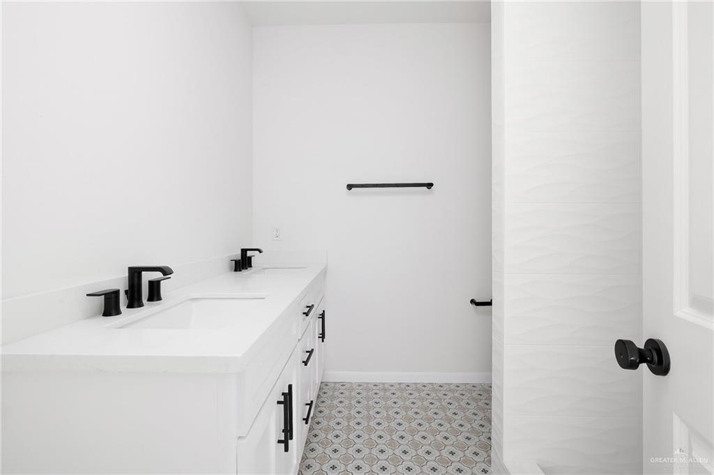 2015 Cassandra Street Mission, TX 78572 - Photo 10 of 15 a bathroom with a sink and mirror