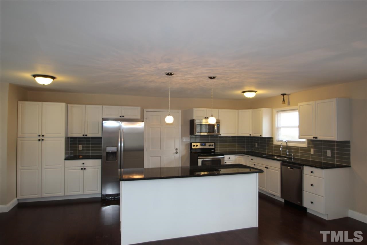 6225 Doyle Road Durham, NC 27712 - Photo 2 of 16 Completely updated kitchen with cabinets, granite counter tops, stainless steel appliances and hardwood floors