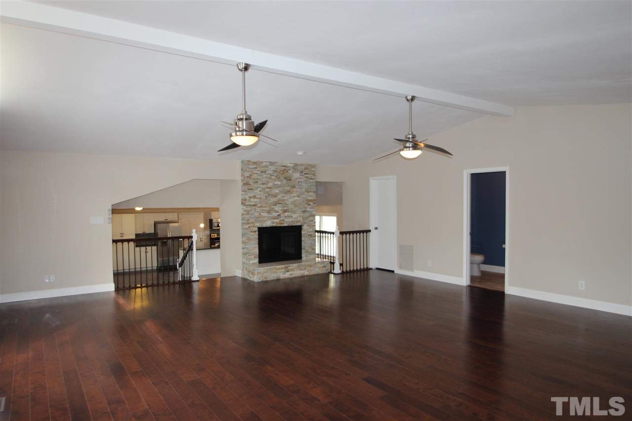 6225 Doyle Road Durham, NC 27712 - Photo 5 of 16 Large family room with fireplace and new hardwood floors