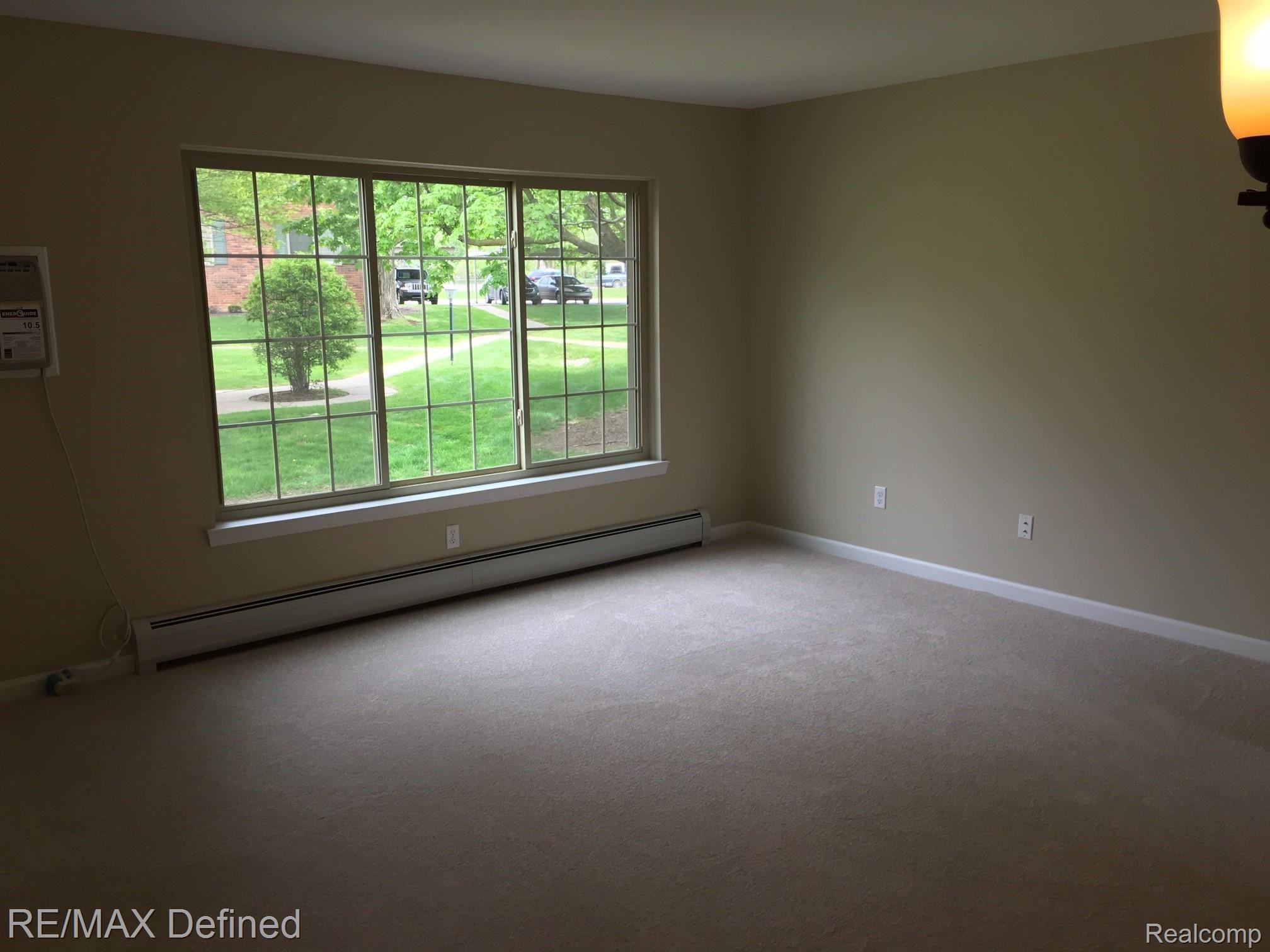 454 Romeo Road, Unit 22 Rochester, MI 48307 - Photo 9 of 18 ROMEO RD LIVING RM.jpeg