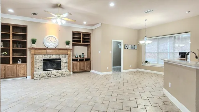 a view of kitchen with a sink and a fireplace
