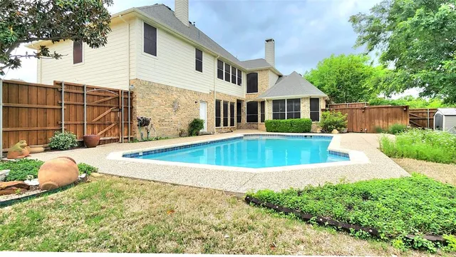 a view of a house with pool and sitting area