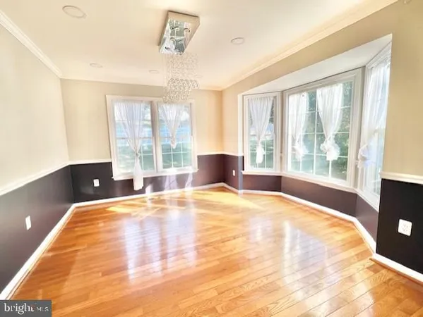 a spacious bedroom with a large bed and a large window