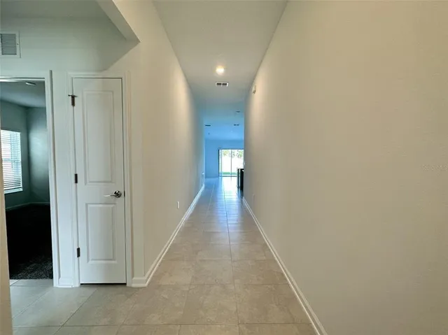 a view of a kitchen with a sink and refrigerator