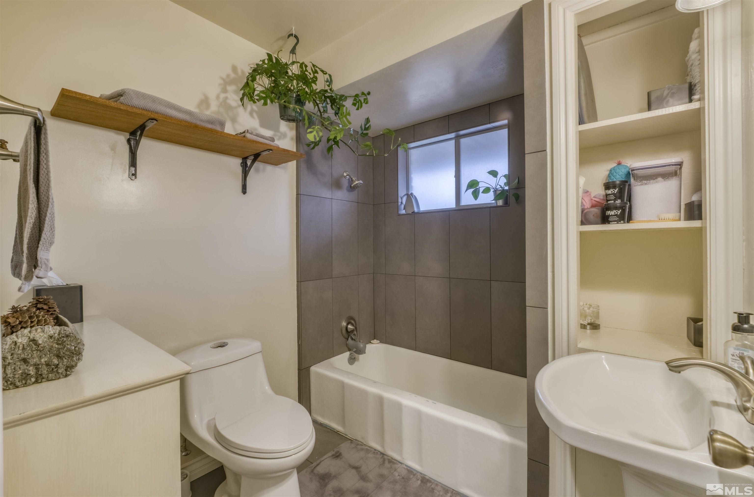 1795 Hunter Lake Drive Reno, NV 89509 - Photo 14 of 32 a white toilet sitting next to a bath tub