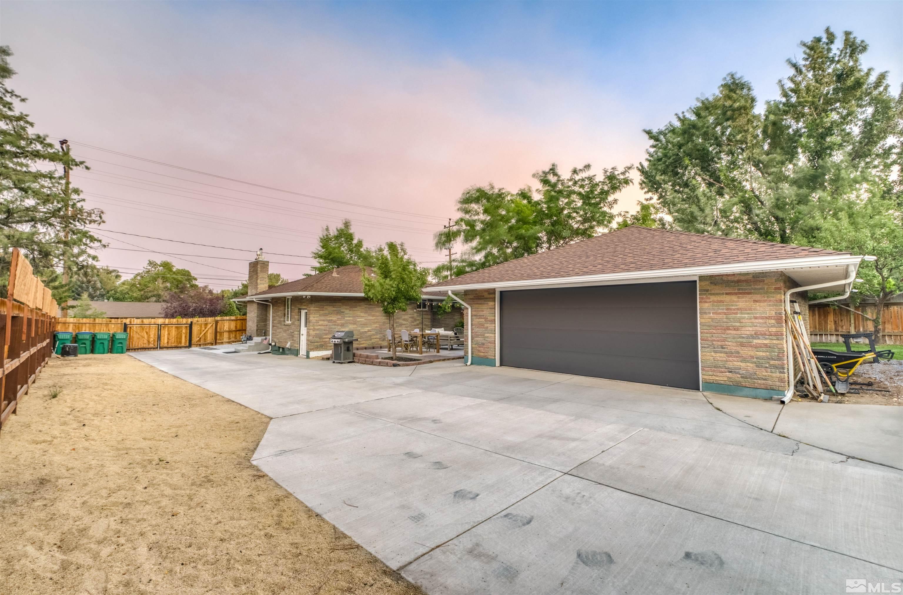 1795 Hunter Lake Drive Reno, NV 89509 - Photo 19 of 32 a view of a house with a yard and garage
