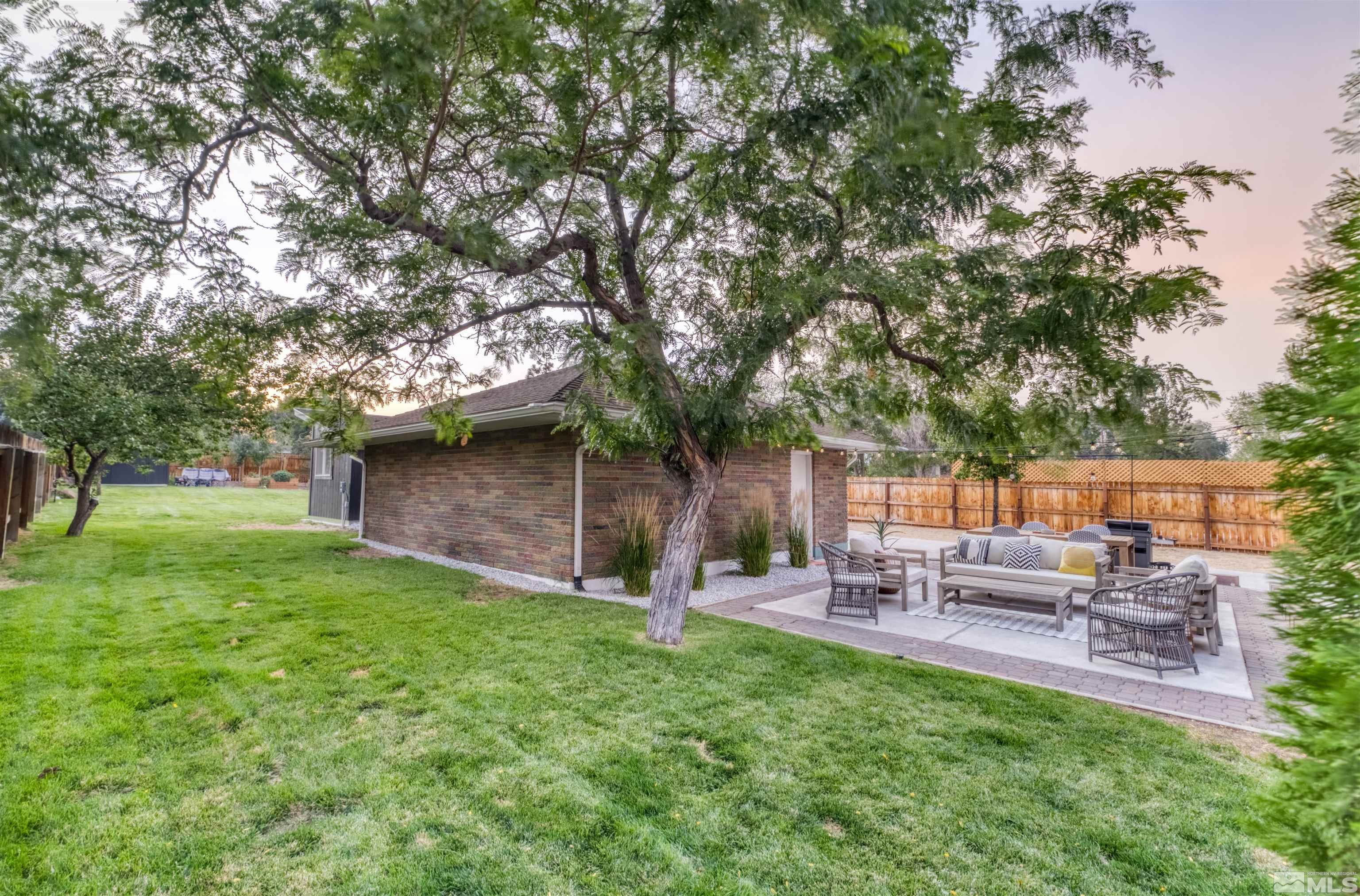 1795 Hunter Lake Drive Reno, NV 89509 - Photo 24 of 32 a backyard of a house with table and chairs