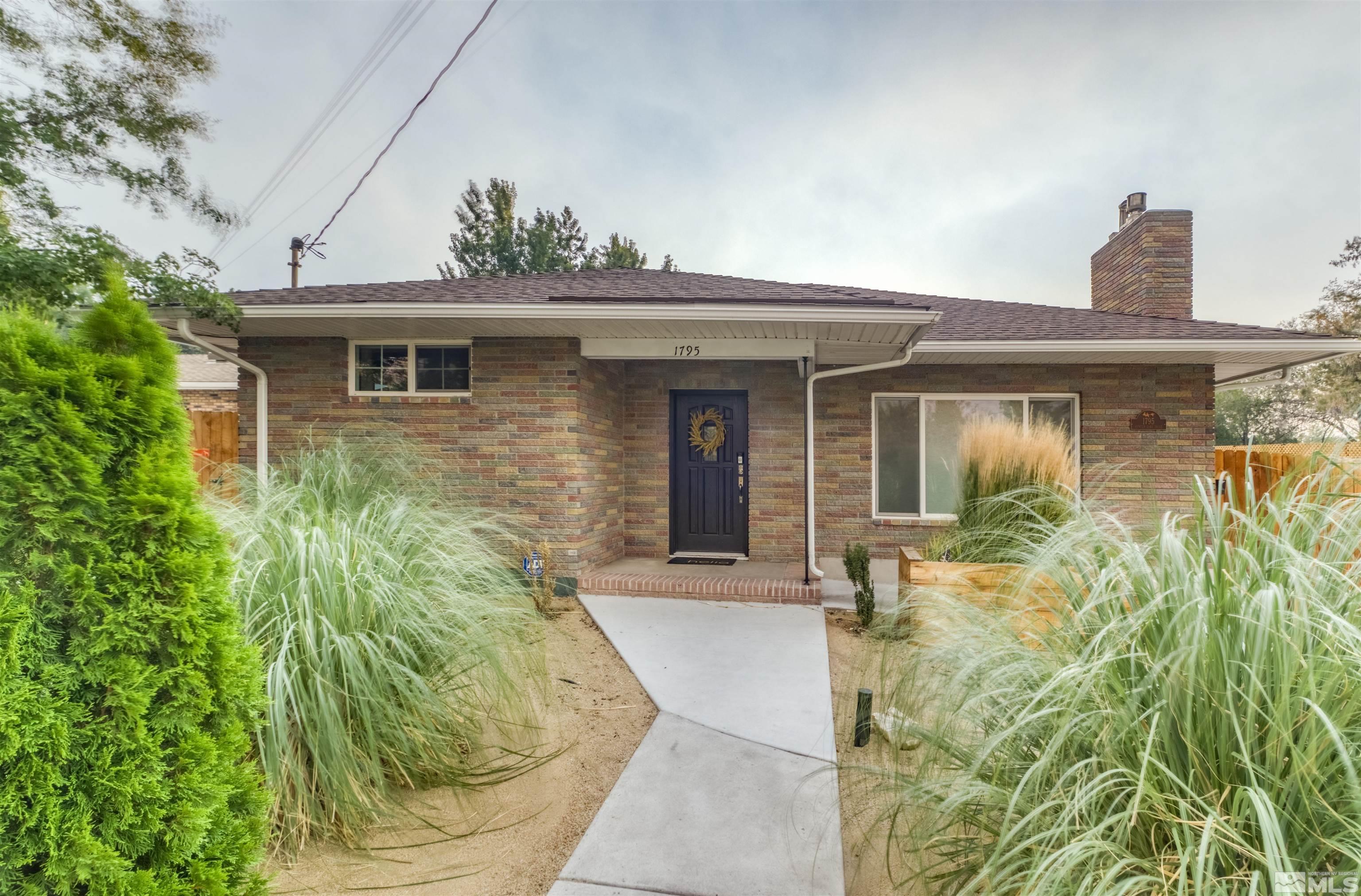 1795 Hunter Lake Drive Reno, NV 89509 - Photo 5 of 32 a front view of a house with garden