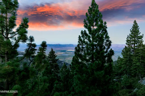 a view of a house with a yard and wooden fence