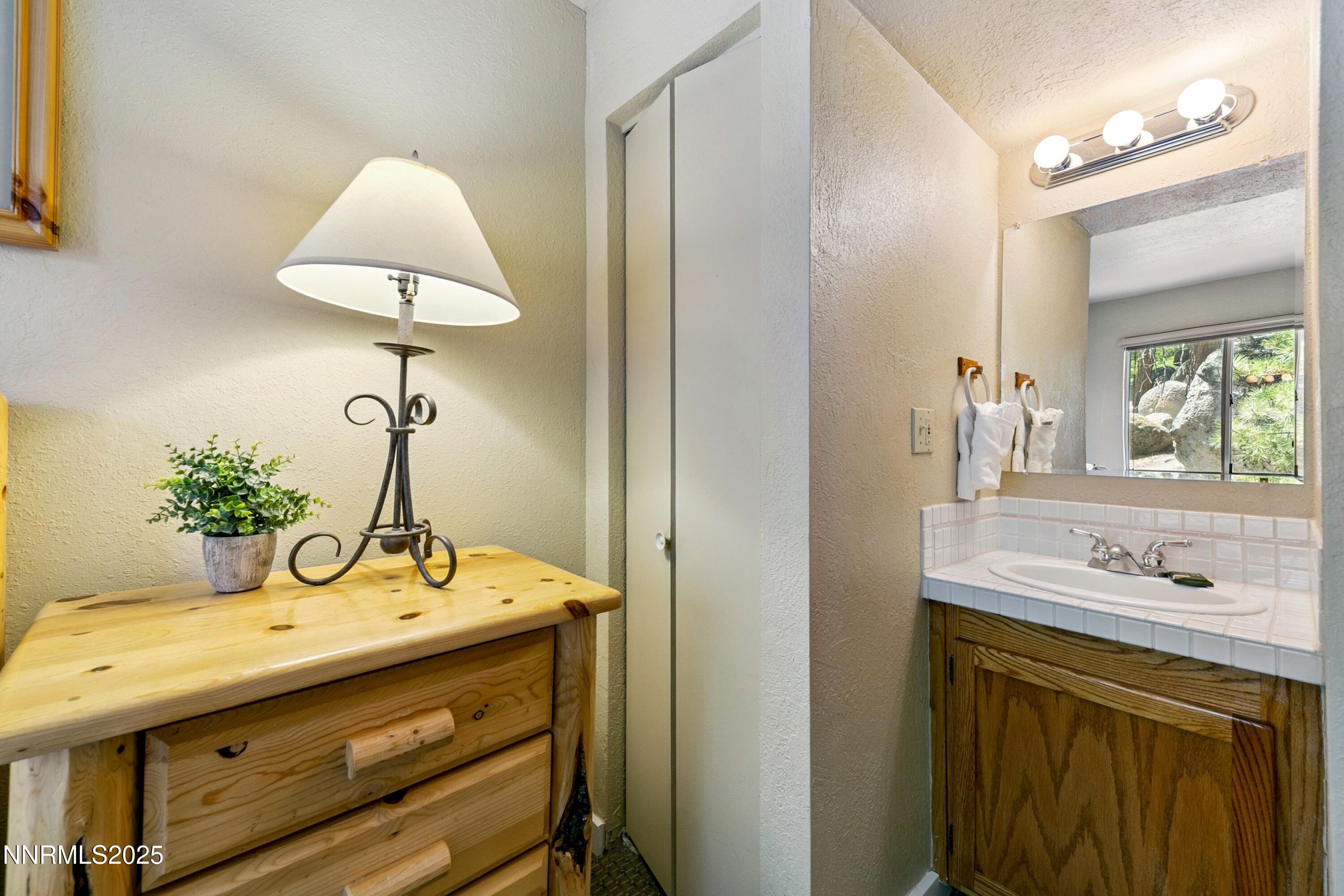 305 Galaxy Lane, Unit 3 Stateline, NV 89449 - Photo 14 of 49 a bathroom with a sink and a mirror