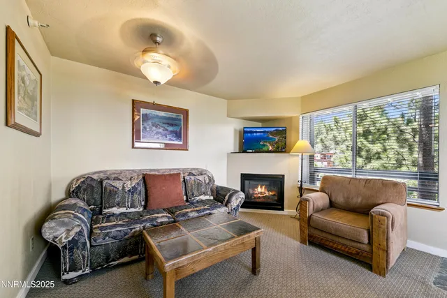 a living room with furniture a dining table and paintings on the wall