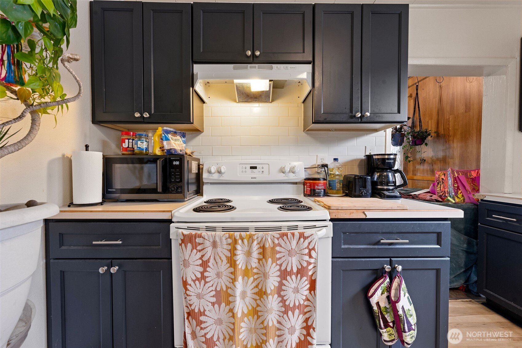 1218 Cedar Street Raymond, WA 98577 - Photo 16 of 31 a kitchen with stainless steel appliances granite countertop a stove a sink and a microwave