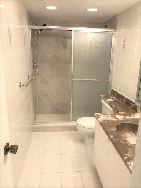 111 Briny Avenue, Unit 806 Pompano Beach, FL 33062 - Photo 13 of 40 a bathroom with a granite countertop sink toilet and shower