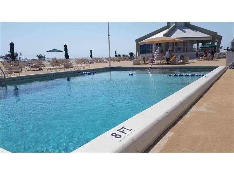 111 Briny Avenue, Unit 806 Pompano Beach, FL 33062 - Photo 21 of 40 a kitchen with a sink and cabinets