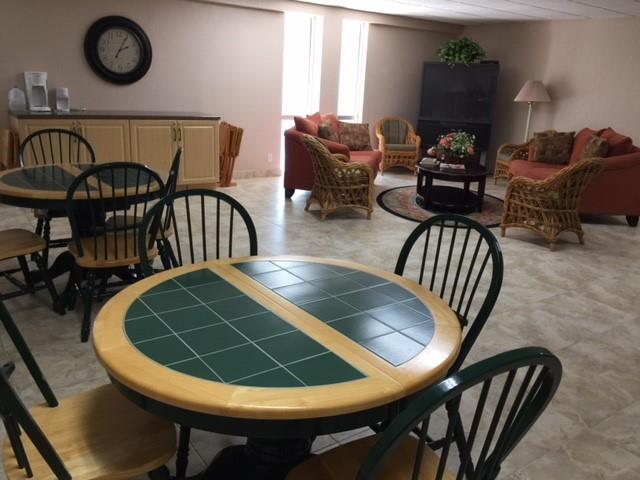 111 Briny Avenue, Unit 806 Pompano Beach, FL 33062 - Photo 27 of 40 a view of a dining room with furniture and wooden floor