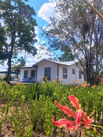 a front view of house with yard and trees