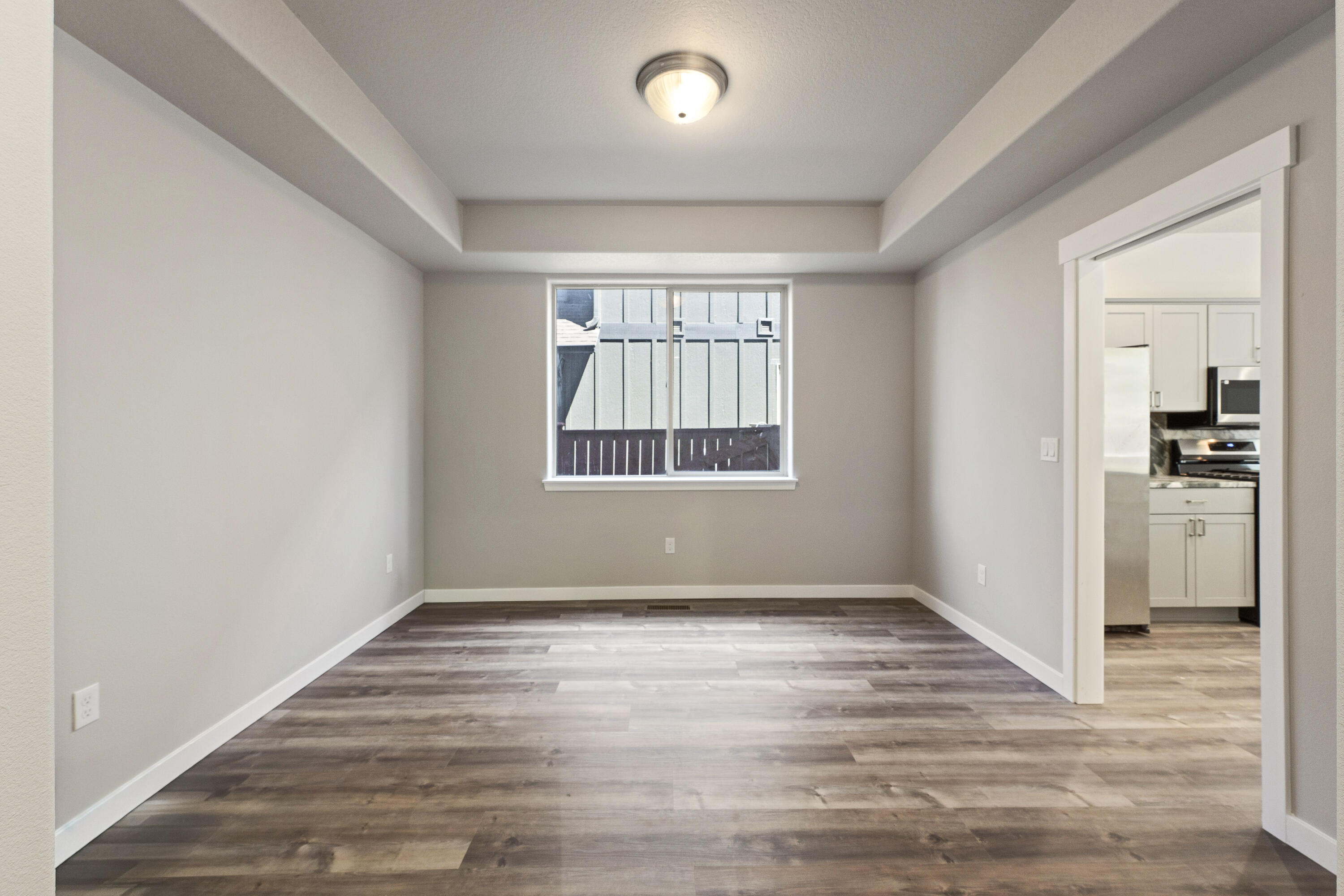 21189 Ritz Place Bend, OR 97702 - Photo 14 of 37 an empty room with wooden floor and windows