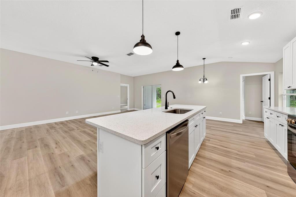 2132 Pine Meadows Golf Course Road Eustis, FL 32726 - Photo 15 of 62 a kitchen with a stove and a wooden floor