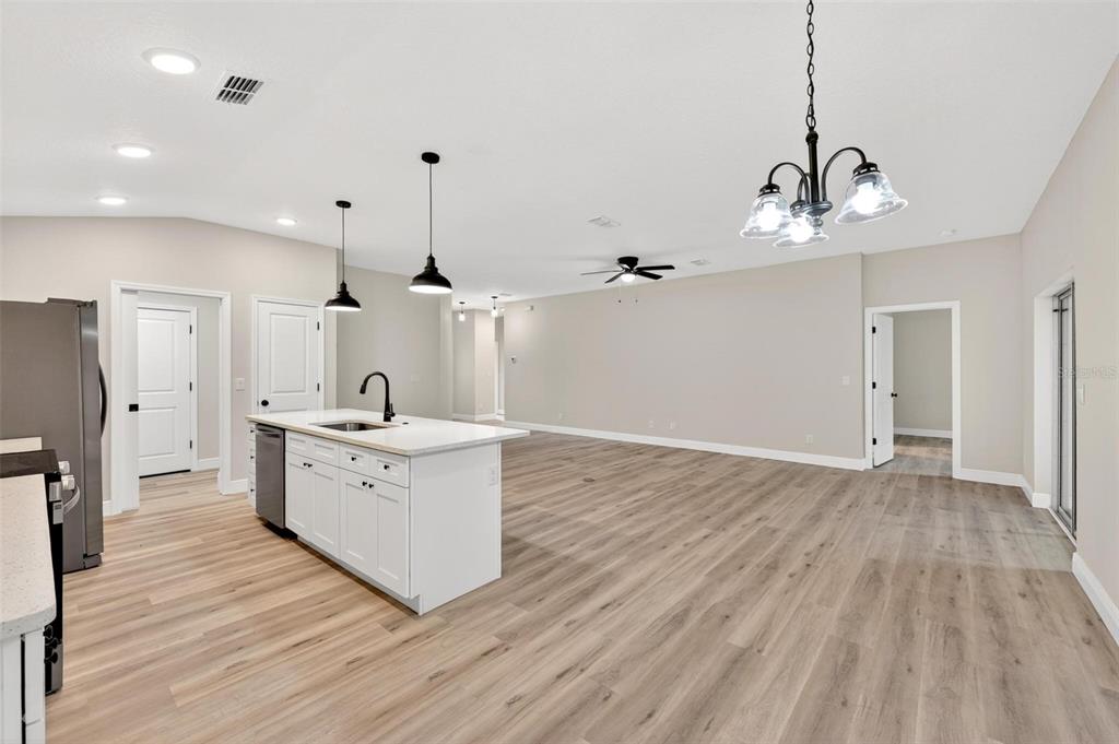 2132 Pine Meadows Golf Course Road Eustis, FL 32726 - Photo 16 of 62 a large kitchen with sink a refrigerator and wooden floor