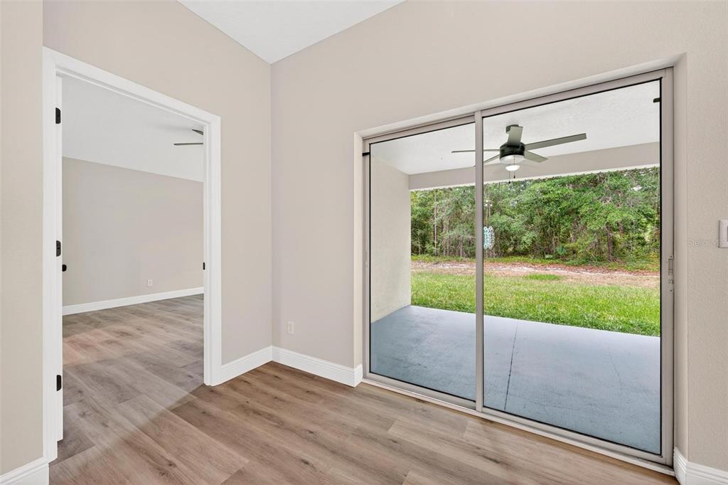 2132 Pine Meadows Golf Course Road Eustis, FL 32726 - Photo 17 of 62 a view of an empty room with wooden floor and a window