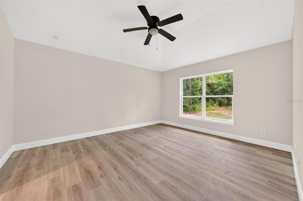 2132 Pine Meadows Golf Course Road Eustis, FL 32726 - Photo 19 of 62 wooden floor in an empty room with a window