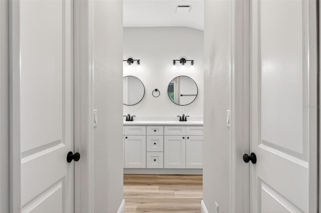 2132 Pine Meadows Golf Course Road Eustis, FL 32726 - Photo 27 of 62 a bathroom with white cabinets and sink