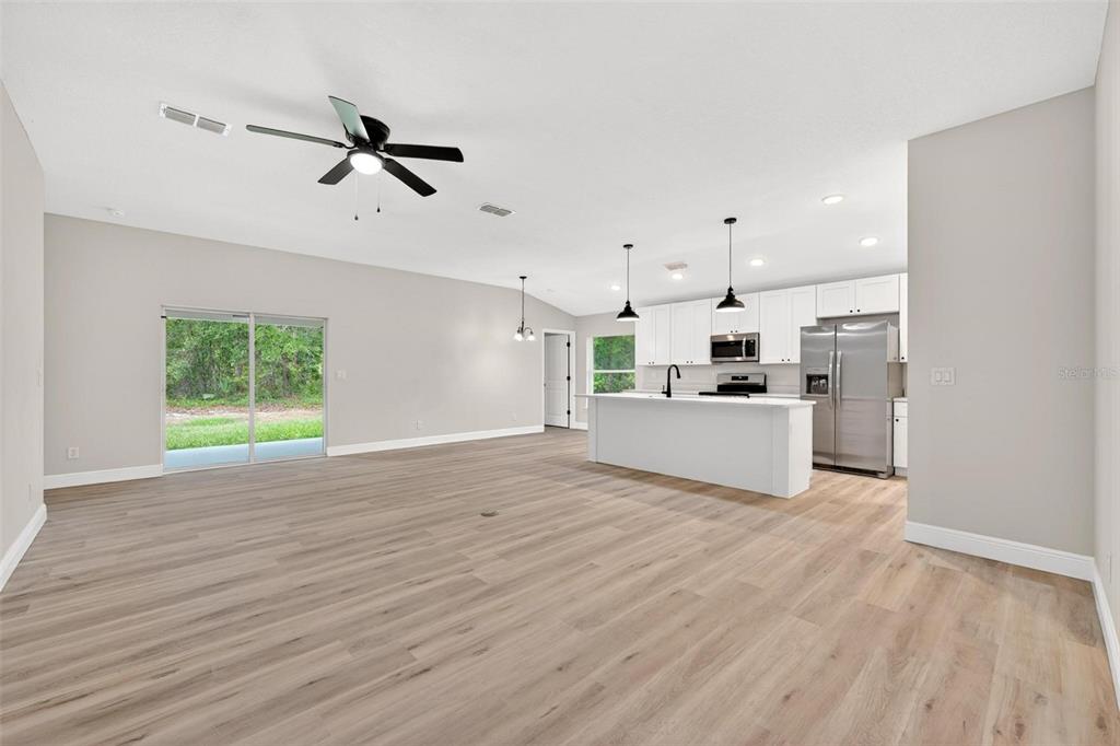 2132 Pine Meadows Golf Course Road Eustis, FL 32726 - Photo 3 of 62 a view of a kitchen with furniture and wooden floor