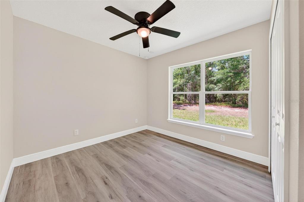 2132 Pine Meadows Golf Course Road Eustis, FL 32726 - Photo 32 of 62 an empty room with wooden floor and windows