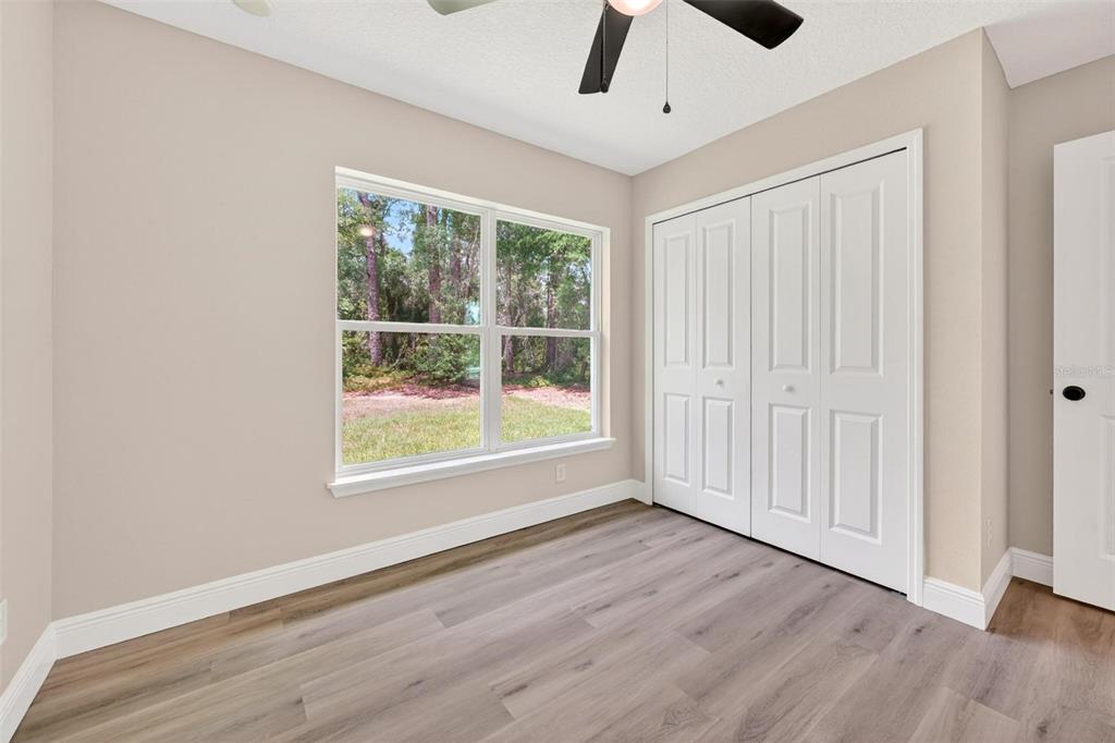 2132 Pine Meadows Golf Course Road Eustis, FL 32726 - Photo 33 of 62 a view of an empty room with wooden floor and a window
