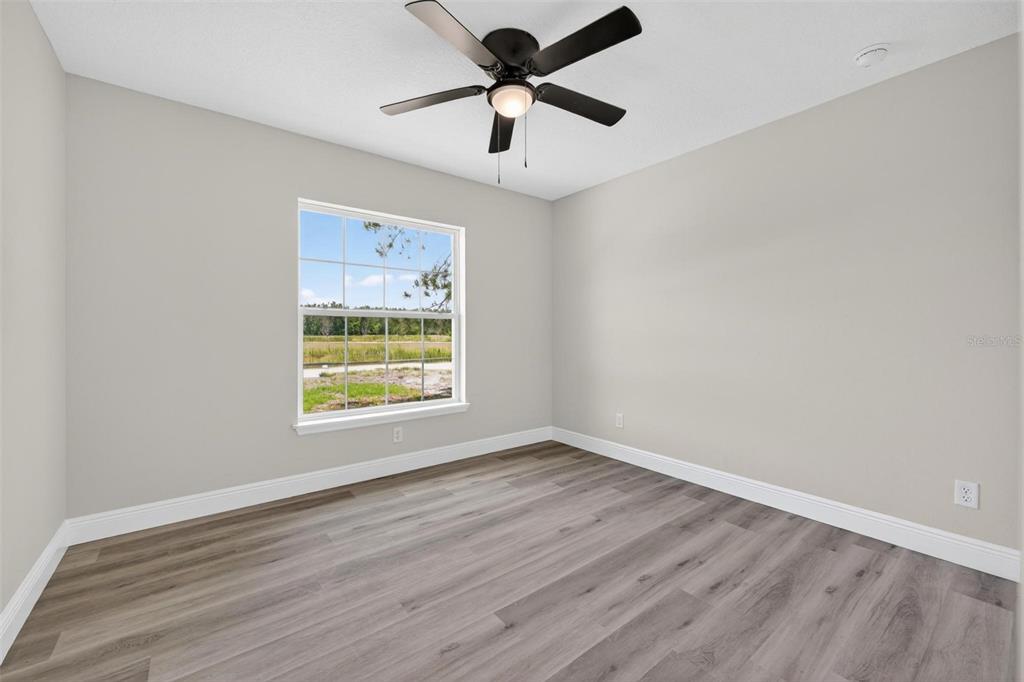 2132 Pine Meadows Golf Course Road Eustis, FL 32726 - Photo 37 of 62 a view of an empty room with window and a chandelier fan