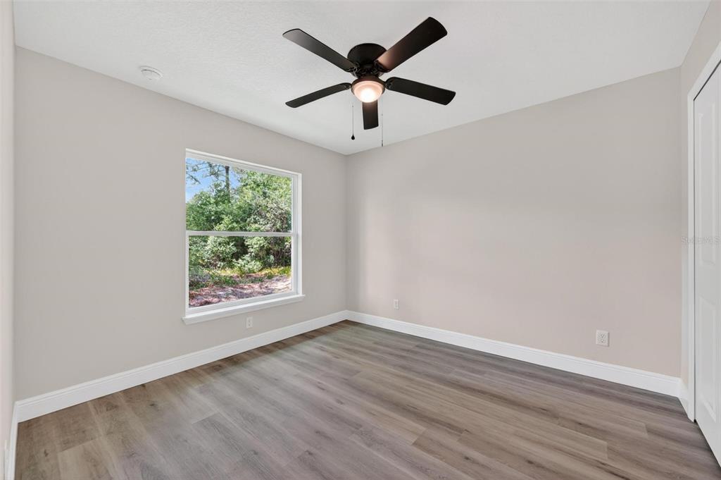 2132 Pine Meadows Golf Course Road Eustis, FL 32726 - Photo 42 of 62 wooden floor in an empty room with a window