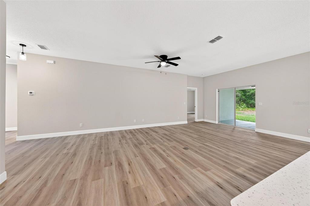2132 Pine Meadows Golf Course Road Eustis, FL 32726 - Photo 5 of 62 a view of an empty room with a window and wooden floor