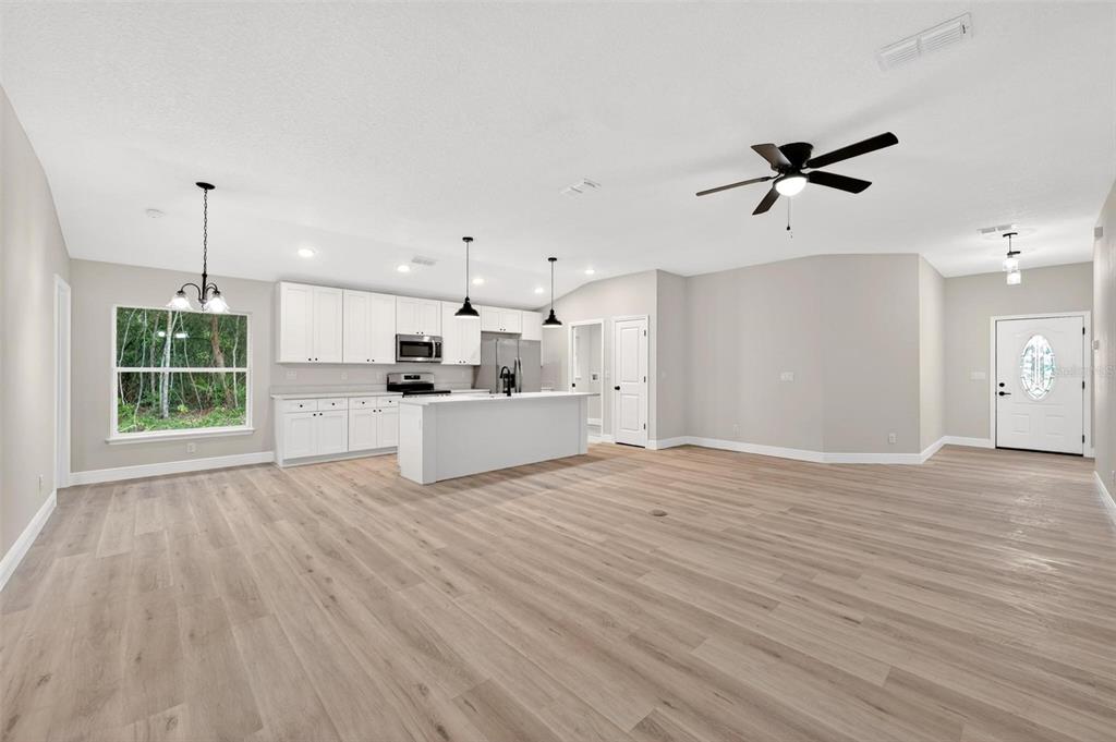 2132 Pine Meadows Golf Course Road Eustis, FL 32726 - Photo 6 of 62 a view of a kitchen with wooden floor and a sink