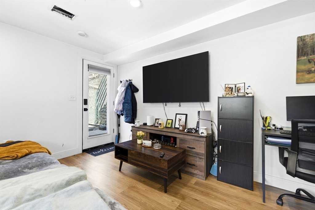 92 Chelsea Street, Unit 1 Boston, MA 02128 - Photo 5 of 14 a living room with furniture and a flat screen tv